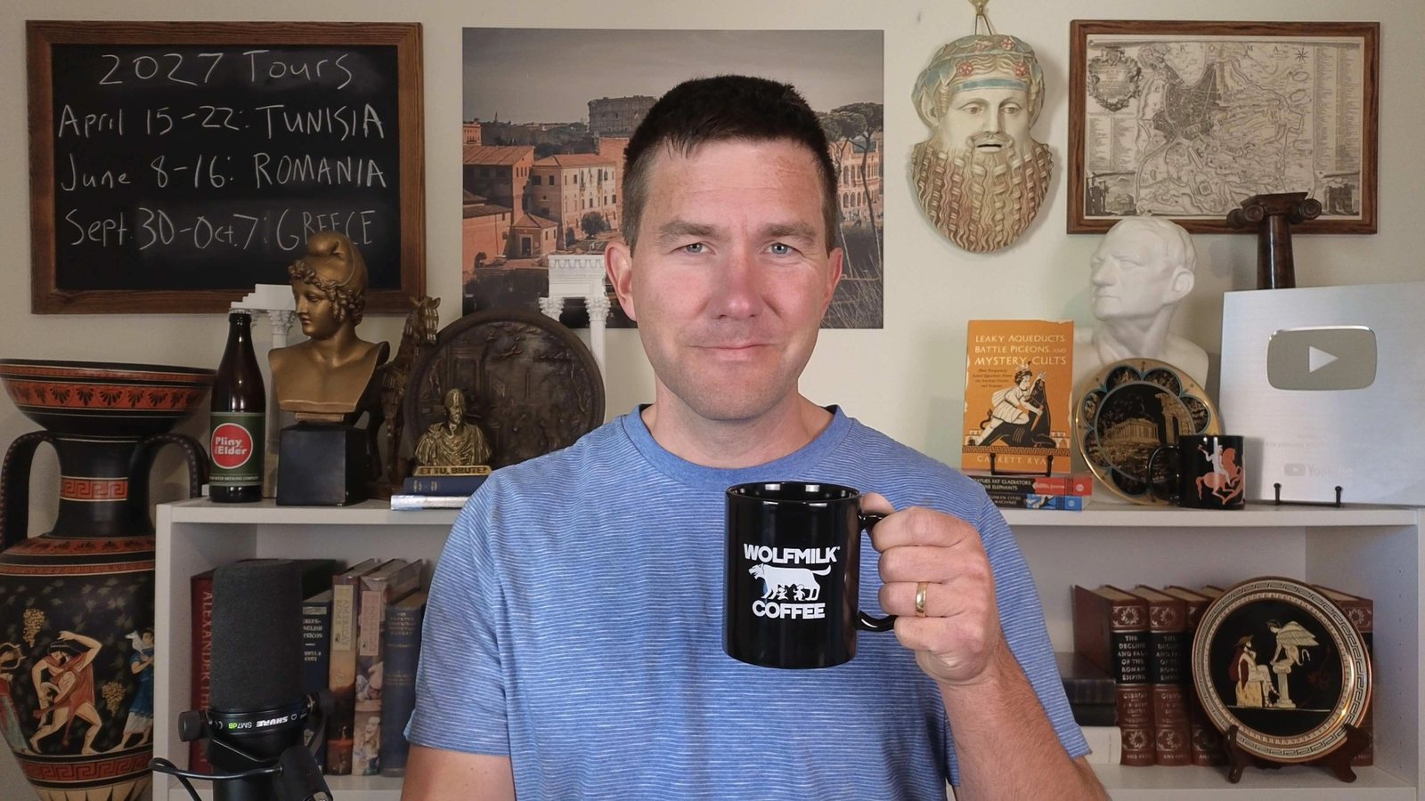 Garrett Ryan of toldinstone holding a Wolfmilk Coffee mug